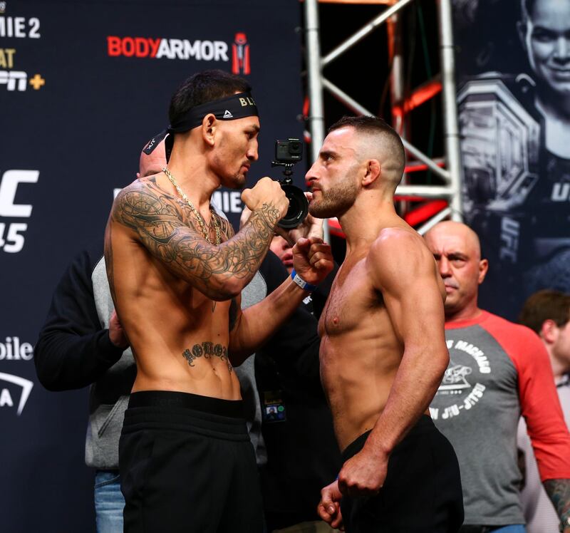 Max Holloway, left, and Alexander Volkanovski face off during the ceremonial weigh-in