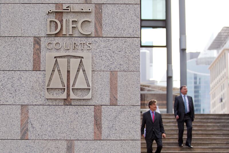 Dubai, Jan 16th, 2012 --  DIFC STOCK - Businessmen walking by DIFC Courts Sign. Photo by: Sarah Dea/ The National