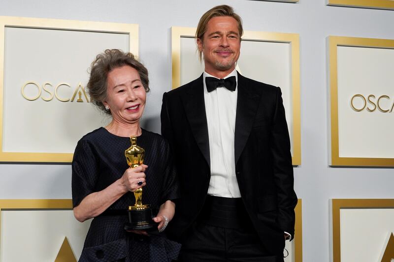 Brad Pitt poses with Youn Yuh-jung in the press room at the Academy Awards in Los Angeles, California. Reuters
