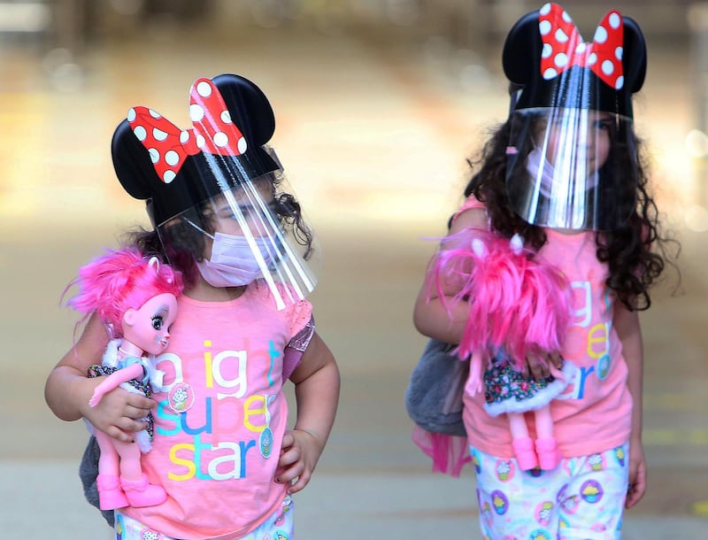 Children travelling from Kuwait international Airport, wear face masks and shields as  protections against the coronavirus, in Farwaniya. AFP