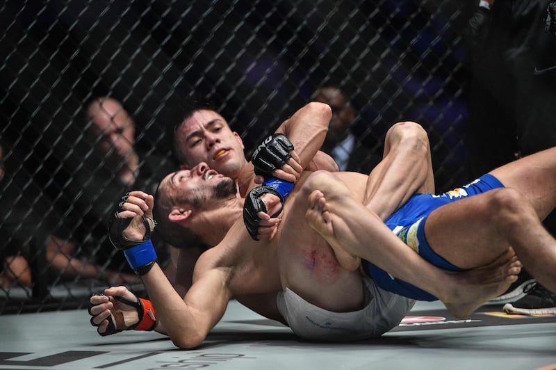 This handout photo taken on December 2, 2016 and received on September 30, 2020 from One Championship shows Mark Striegl of the Philippines (white shorts) fighting Sotir Kichukov of Bulgaria during their ONE Championship catchweight mixed martial arts bout at Mall of Asia Arena in Manila. Striegl makes his UFC debut in Abu Dhabi on October 18, 2020 having taken a path forged by centuries of feared Filipino warriors and followed by boxing great Manny Pacquiao. - TO GO WITH AFP STORY MMA-UFC-PHI-USA-Striegl /
RESTRICTED TO EDITORIAL USE - MANDATORY CREDIT "AFP PHOTO / ONE CHAMPIONSHIP / DAVID ASH" - NO MARKETING NO ADVERTISING CAMPAIGNS - DISTRIBUTED AS A SERVICE TO CLIENTS --- NO ARCHIVES ---

 / AFP / ONE CHAMPIONSHIP / David ASH / TO GO WITH AFP STORY MMA-UFC-PHI-USA-Striegl /
RESTRICTED TO EDITORIAL USE - MANDATORY CREDIT "AFP PHOTO / ONE CHAMPIONSHIP / DAVID ASH" - NO MARKETING NO ADVERTISING CAMPAIGNS - DISTRIBUTED AS A SERVICE TO CLIENTS --- NO ARCHIVES ---

