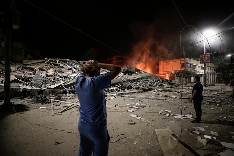 Palestinians view aftermath of an Israeli air strike on Gaza city. EPA