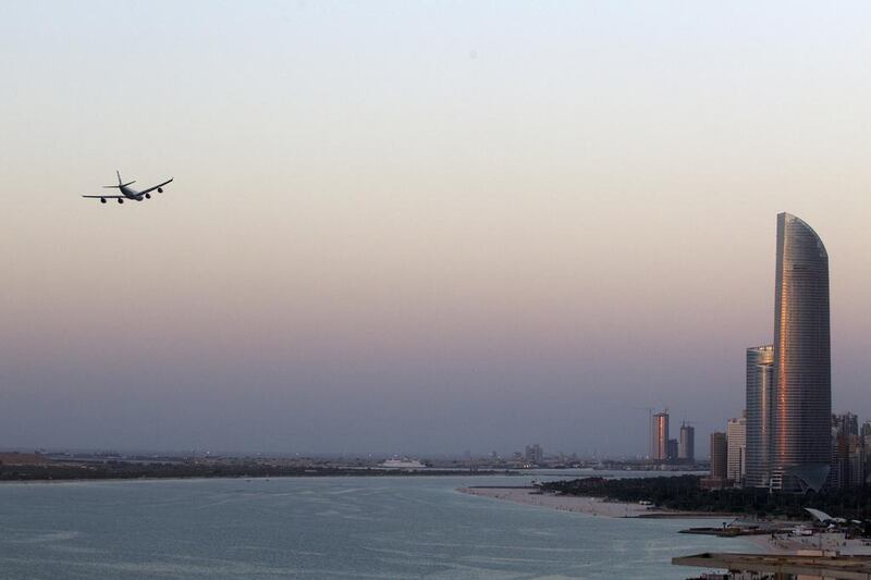 An Etihad airplane flys over the Corniche in Abu Dhabi on November 10, 2013. Christopher Pike / The National

