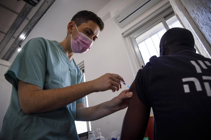 A nurse administers a dose of the Pfizer Inc.-BioNTech SE Covid-19 vaccine to a foreign national at a vaccination centre in Tel Aviv, Israel. Bloomberg