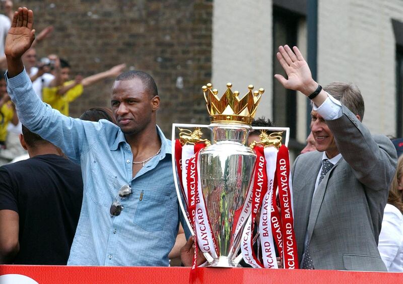 (FILES) In this file photo taken on May 16, 2004 Arsenal team captain Patrick Vieira (L) and manager Arsen Venger wave from the open-top bus carrying the winners of the British Premier League Championship, Arsenal players and their families, on  its way to Islington Town Hall,16 May  2004, as part of the Club's victory celebration.       
Arsene Wenger will bring his 22-year stay in charge of Arsenal to a close at the end of the season, the Frenchman announced on April 20, 2018. / AFP PHOTO / Martin HAYHOW