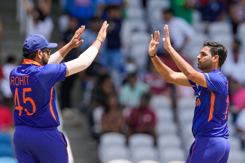 India's Bhuvneshwa Kumar, right, celebrates with captain Rohit Sharma the dismissal of Shamarh Brooks. AP
