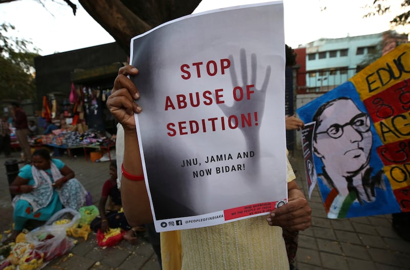 A woman holds a placard protesting against a sedition case filed by police against a school after a play performed by students denounced a new citizenship law, in Bangalore. AP