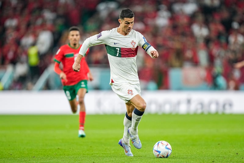 Portugal's Cristiano Ronaldo runs with the ball after coming on in the second half. AP