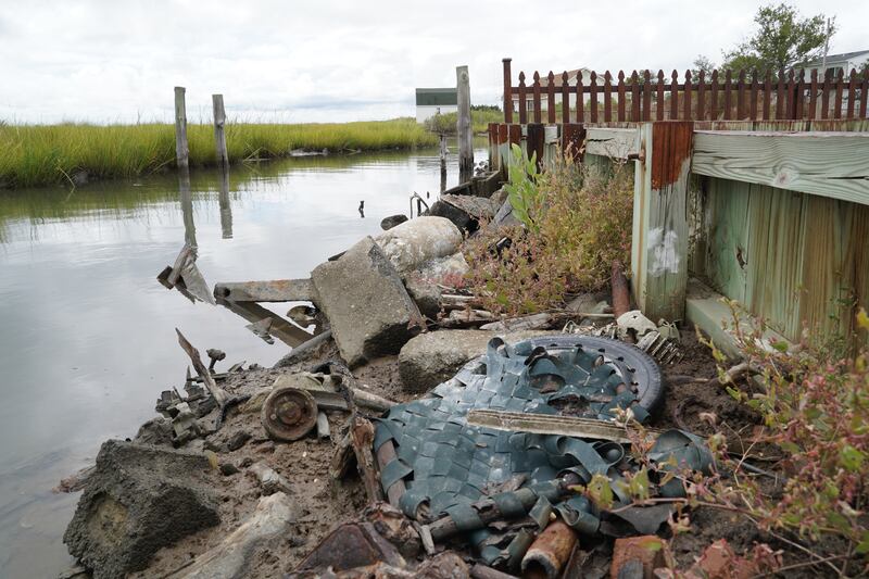 Debris is stacked against the shoreline in an effort to prevent erosion. The island loses as much as nine metres of shoreline a year to erosion. 