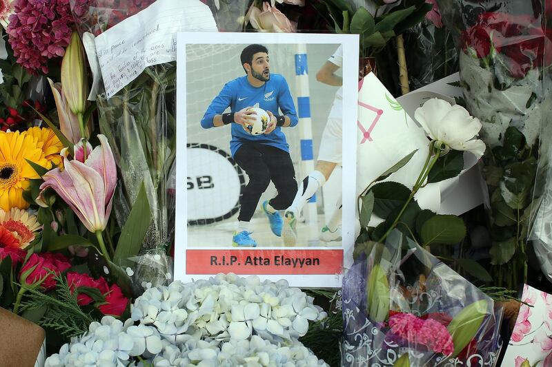 A photograph of New Zealand futsal player Atta Elayyan, victim of the Christchurch mosque attacks, sits amongst floral tributes near the Al Noor mosque in Christchurch on March 18, 2019.  The Australian charged with murder in the mass shootings at two New Zealand mosques plans to represent himself and appears "rational", his court-appointed lawyer told AFP. / AFP / DAVID MOIR
