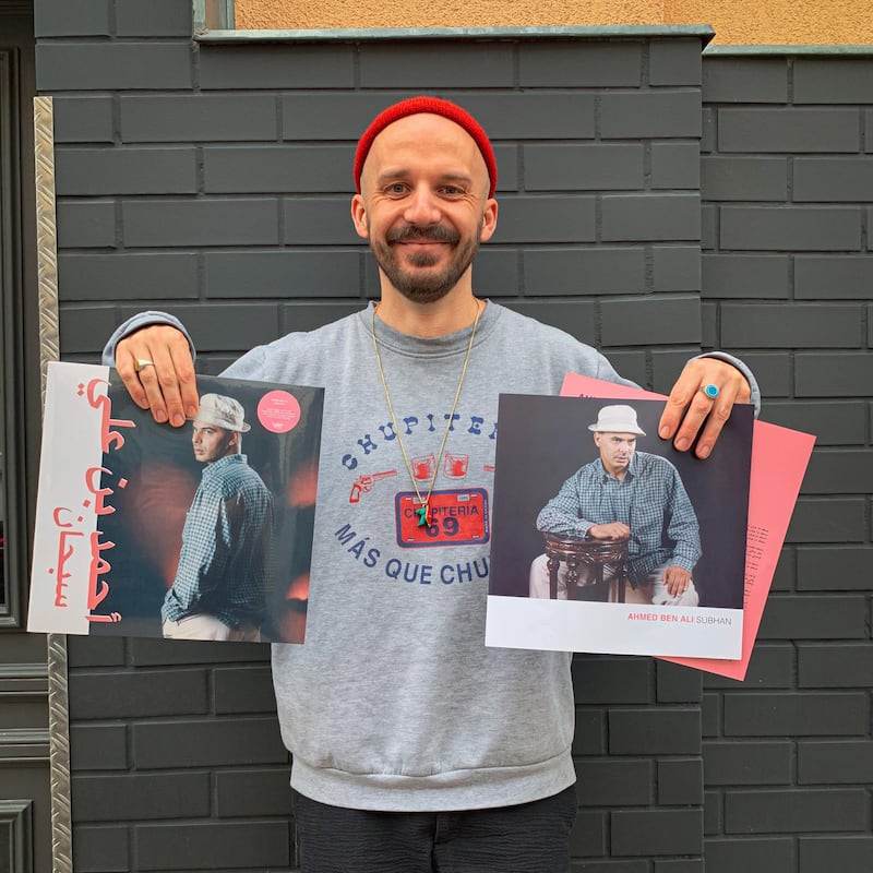 Jannis Sturtz, aka Habibi Funk, with his label's 12th release, a 12-inch vinyl by Libyan producer and singer Ahmed Ben Ali. Courtesy Habibi Funk