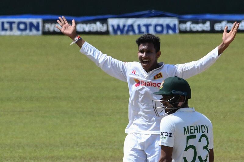 Sri Lanka's Praveen Jayawickrama celebrates after he dismissed Bangladesh's Liton Das (C) during the final day of the second and final Test cricket match between Sri Lanka and Bangladesh at the Pallekele International Cricket Stadium in Kandy on May 3, 2021.  / AFP / LAKRUWAN WANNIARACHCHI
