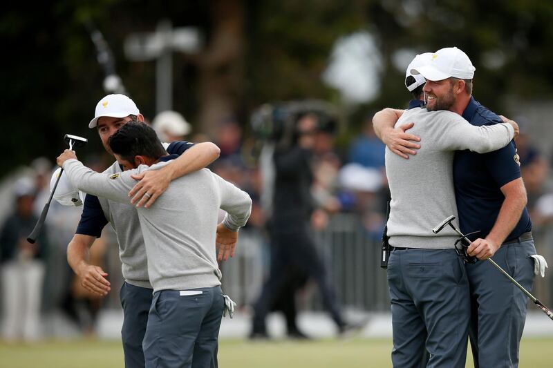Leishman and Abraham Ancer celebrate with Louis Oosthuizen  after halving their match. Getty