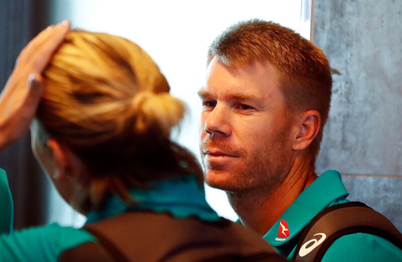 epa06631761 Australian cricket player David Warner (R) departs from Cape Town International airport, South Africa, 27 March 2018. Australia skipper Steve Smith has been suspended by the International Cricket Council (ICC) for his part in a ball tampering scandal during the third test against South Africa. Smith admitted some senior players were aware of the ball tampering attempt. Smith and Warner stepped down as captain and vice-captain of the Australian team in consequence to the ball meddling scandal.  EPA/NIC BOTHMA