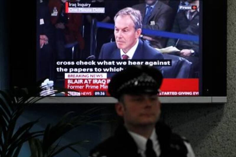 A police officer stands in front of a television screen in the foyer of the venue hosting the Iraq Inquiry in London, as Britain's former Prime Minister Tony Blair speaks, Friday, Jan. 29, 2010. Blair faced tough questioning Friday on his controversial decision to back the 2003 U.S.-led invasion of Iraq, a pledge that led to widespread protests in Britain and weakened his standing as leader. (AP Photo/Matt Dunham)