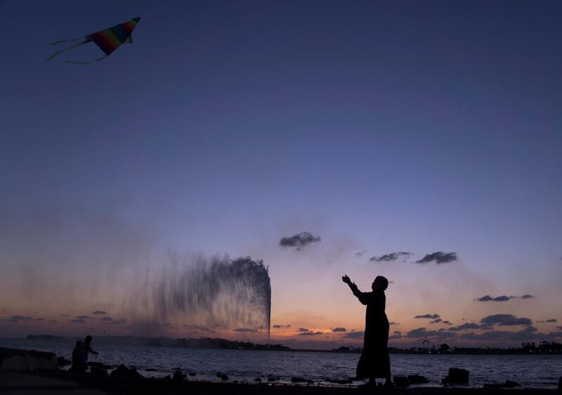 FILE- In this Monday, Feb. 20, 2017 file photo, a boy flies a kite on the Red Sea beach near the landmark Jiddah fountain, in Jiddah, Saudi Arabia. Saudi Arabia is planning to build a semi-autonomous luxury travel destination along its Red Sea coast that visitors can reach without a visa. The Red Sea area, which will include diving attractions and a nature reserve, will be developed with seed capital from the country's Public Investment Fund. (AP Photo/Amr Nabil, File)