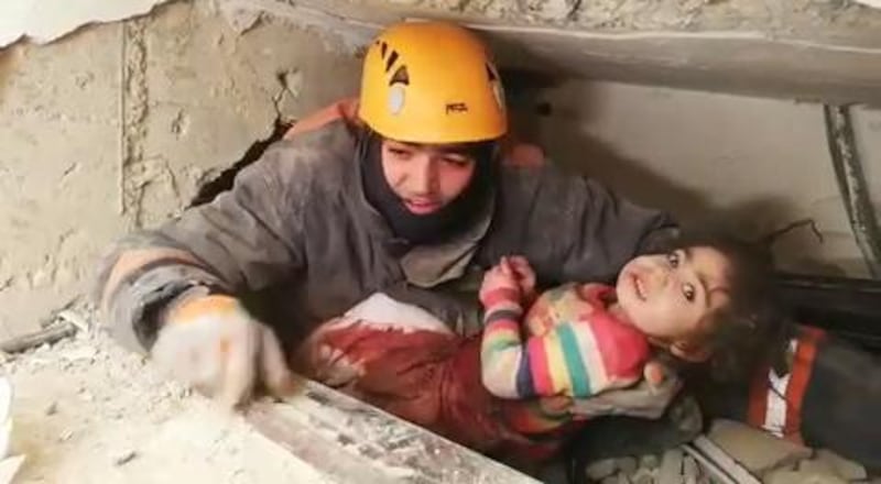 A rescuer pulling two-year-old girl Nusra Yildiz from the rubble of a collapsed buidling after an earthquake, in Mustafa Pasa district in Elazig, Turkey.  EPA