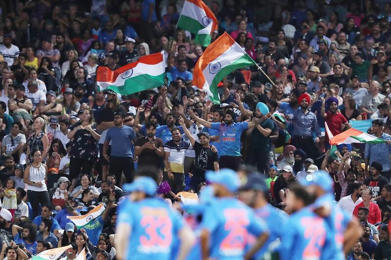 Indian fans celebrate after New Zealand's Tim Seifert was dismissed during the third Twenty20 international cricket match between New Zealand and India in Hamilton on February 10, 2019. / AFP / MICHAEL BRADLEY
