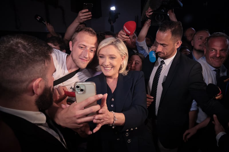 Marine Le Pen, candidate for the far-right National Rally party, with supporters in Paris. EPA