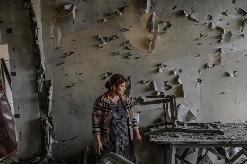 Xatire Celilova stands inside her destroyed flat after a ceasefire, in Terter, Azerbaijan. AFP