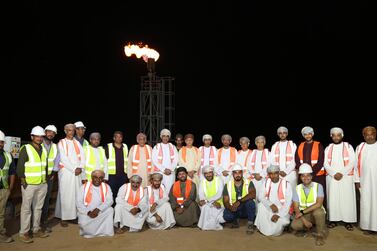 Staff from the new Mazoon Dairy in Oman in front of a new flaring tower for the facility's biogas plant. The plant will start production by the end of the month and aims to produce more than 200 million litres of dairy products by 2026. Courtesy Mazoon Dairy Company