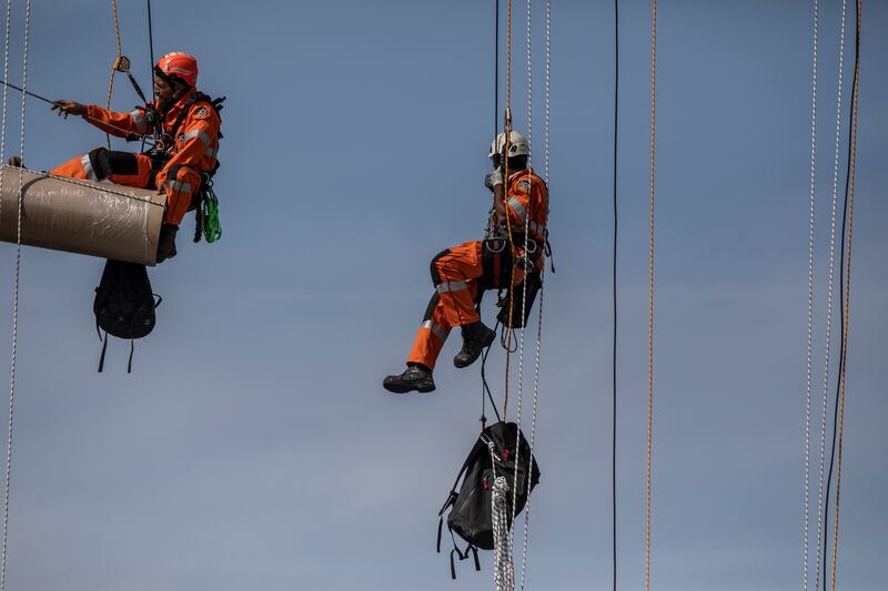 Workers begin the process of wrapping up the Arc De Triomphe. Getty Images