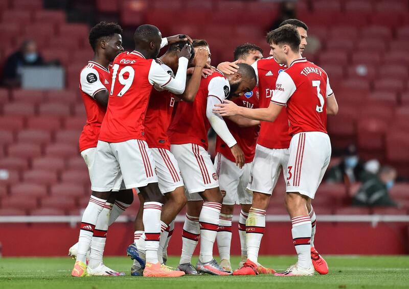 Arsenal players celebrate after Reiss Nelson (3rd L) scored their second goal. AFP