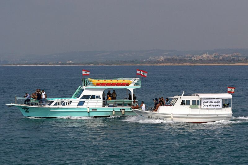 Protesters with slogans on their boats asserting Lebanon's right to its offshore gas wealth. AFP