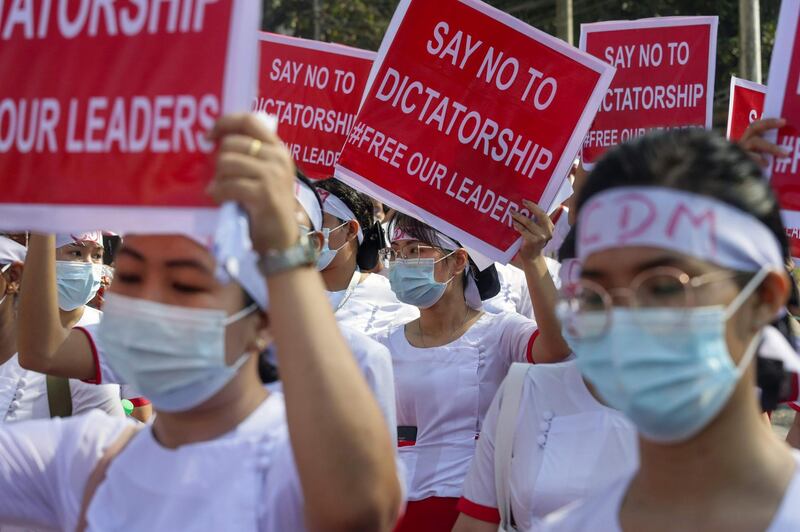 Nurses hold up signs as they march during a demonstration against the military coup in Yangon. AFP