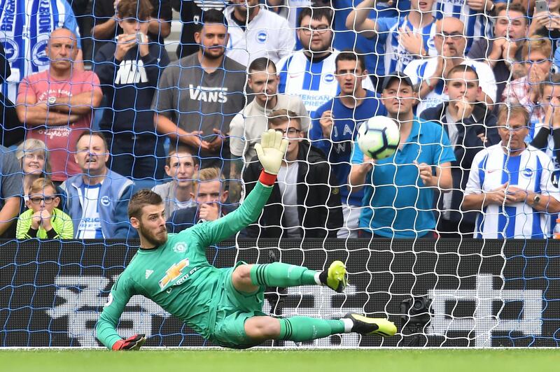 Manchester United's David de Gea attempts to make a save from Brighton's penalty. AFP