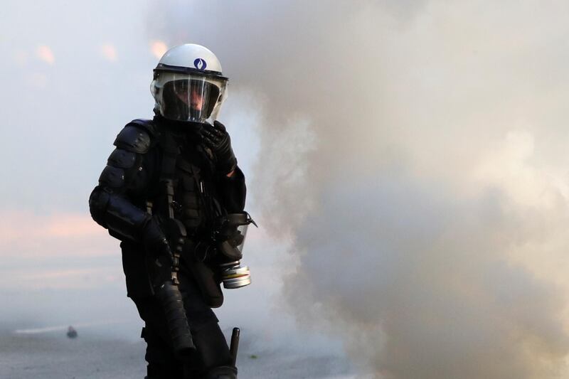 A police officer looks on during clashes as people gather at the Bois de la Cambre/Ter Kamerenbos park for a party called "La Boum 2" in defiance of Belgium's coronavirus disease (COVID-19) social distancing measures and restrictions, in Brussels, Belgium May 1, 2021. REUTERS/Yves Herman