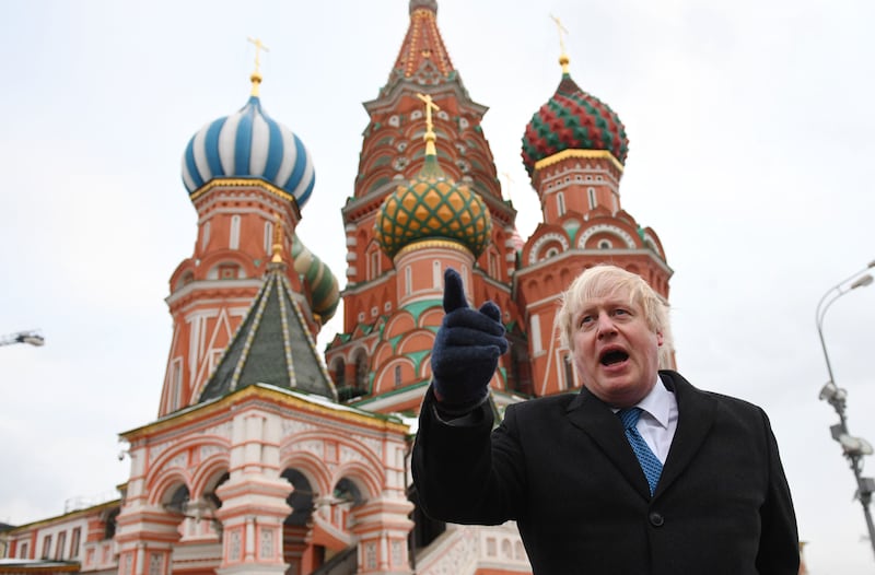 Mr Johnson, then Britain's foreign secretary, stands in front of St Basil's Cathedral during a visit to Moscow's Red Square in December 2017. Getty