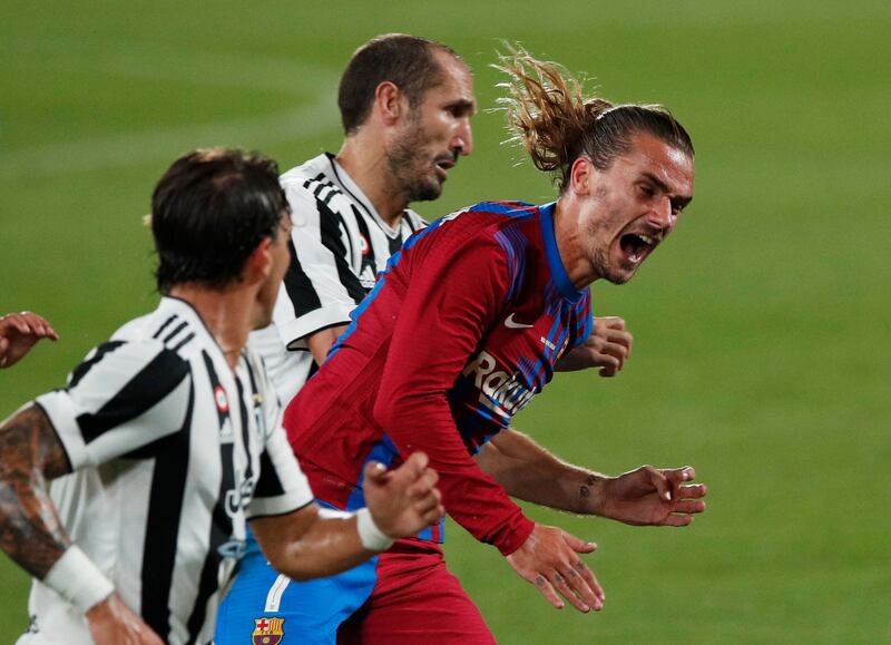 Barcelona's Antoine Griezmann in action with Juventus' Giorgio Chiellini.