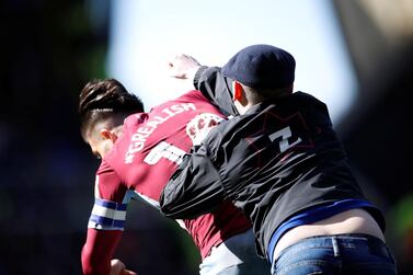 A fan invades the pitch and attacks Aston Villa midfielder Jack Grealish during the match at St Andrews. Reuters