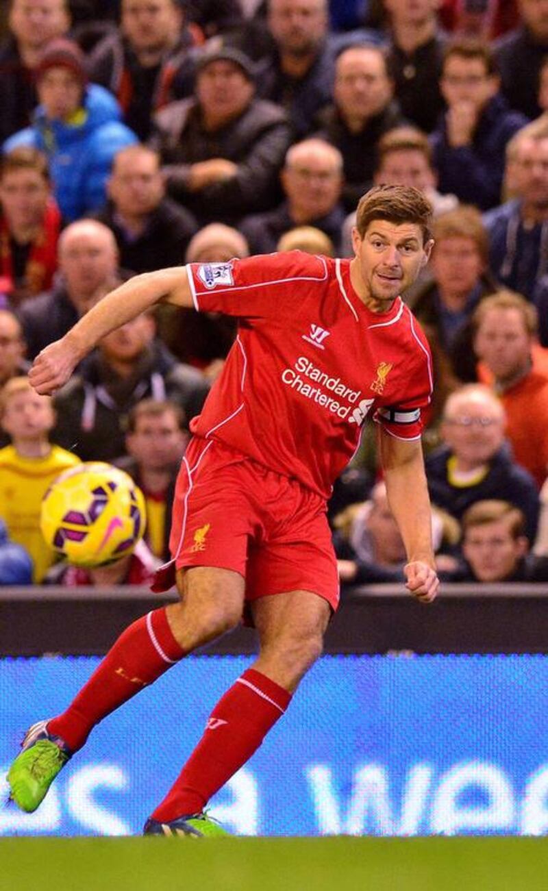 Liverpool's English midfielder Steven Gerrard, centre, is being offered a new contract. Paul Ellis / AFP