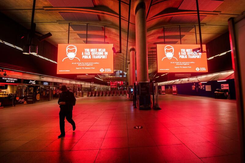 A solitary person on the concourse at Canary Wharf underground station during the morning rush hour in London. AP Photo