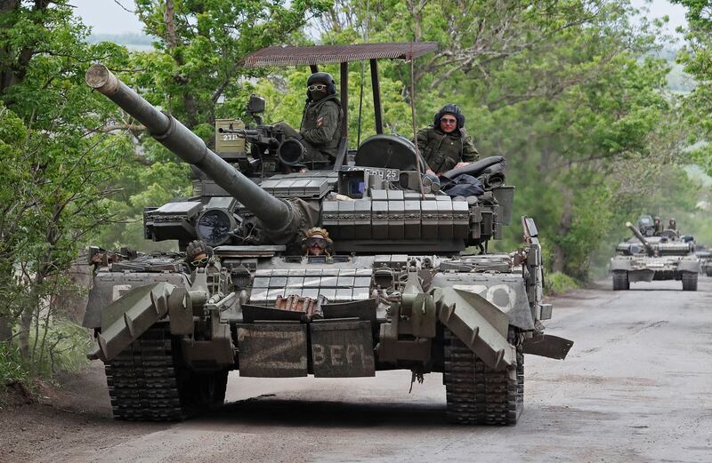 Pro-Russian troops drive a tank in Ukraine's Donetsk region. Reuters