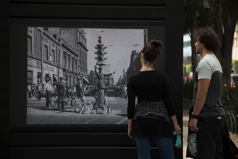 A couple looks at s a photograph of the "Roma Photo Exhibit" on Alvaro Obregon Avenue, in Mexico City, Saturday, Feb. 9, 2019. As part of the activities organized in the framework of the Oscars ceremony and due to the nomination of the film ROMA by Mexican Director Alfonso Cuaron, Mexico Cityâ€™s government inaugurated the "Roma Photo Exhibition" which are a series of photographs of the Roma neighborhood through time. (AP Photo/Christian Palma)