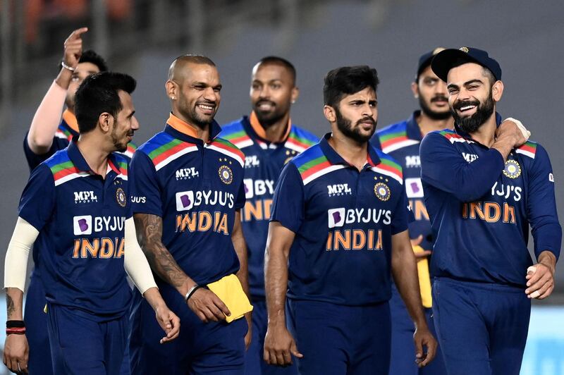 India's captain Virat Kohli (R) and teammates walk back to the pavilion at the end of the match. AFP