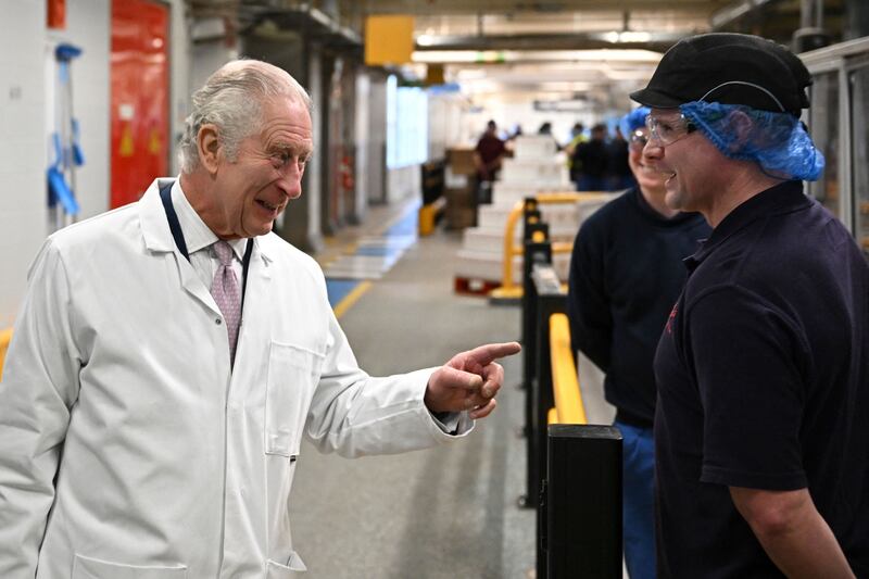 King Charles III speaks to staff on the cornflakes production line during a visit to Kellogg's in Manchester, north-west England. AFP