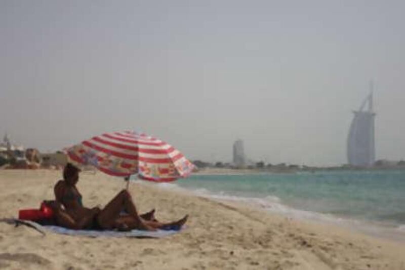 A couple enjoys an afternoon at the Jumeirah beach in Dubai.