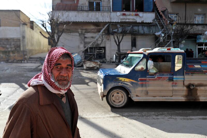 A Syrian man walks past the site a suicide attack targeting US-led coalition forces in the flashpoint northern Syrian city of Manbij which killed four US serviceman the previous day on January 17, 2019.


 The bombing, claimed by the Islamic State group, comes after US President Donald Trump's shock announcement last month that he was ordering a full troop withdrawal from Syria because the jihadists had been "largely defeated".
 / AFP / Delil SOULEIMAN
