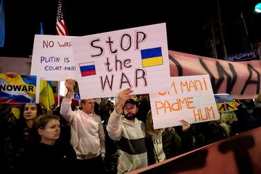 A protester holds a poster reading 'Stop the War' as members of the Russian community gather to demonstrate in opposition to the Russian invasion of Ukraine next to the Andrei Sakharov Square in Studio City, California, USA, 24 February 2022.   EPA / ETIENNE LAURENT
