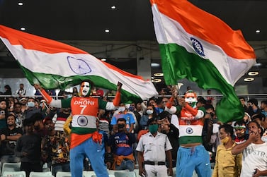 Cricket fans wave Indian national flag after India's victory in the third Twenty20 International cricket match between India and New Zealand at the Eden Gardens in Kolkata on November 21, 2021.  (Photo by DIBYANGSHU SARKAR  /  AFP)  /  ----IMAGE RESTRICTED TO EDITORIAL USE - STRICTLY NO COMMERCIAL USE-----