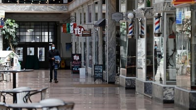 FILE - In this May 7, 2020 file photo, a man walks through the 5th Street Arcade, a selection of indoor shops closed during the pandemic in Cleveland.  The U.S. unemployment rate hit 14.7% in April, the highest rate since the Great Depression, as 20.5 million jobs vanished in the worst monthly loss on record. The figures are stark evidence of the damage the coronavirus has done to a now-shattered economy.(AP Photo/Tony Dejak, File)