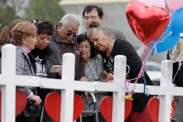Family and friends gather around a memorial for the victims of the First Baptist Church shooting in Sutherland Springs, Texas on November 10, 2017. AP Photo