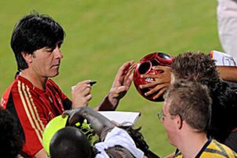 Germany's coach Joachim Loew signs autographs during training ahead of Tuesday's 7-2 friendly victory over the UAE in Dubai.