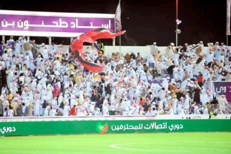 Football fans flee in panic at the moment a paraglider and its engine crashed into a stand at the Tahnoun bin Mohammed Stadium in Al Ain last night.