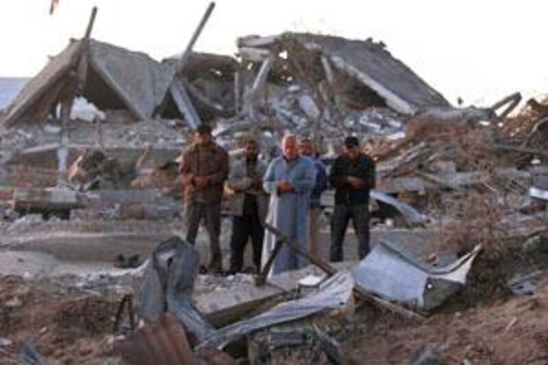 Palestinians pray next to the rubble of houses destroyed in last month's Israeli military offensive, in Jebaliya, northern Gaza Strip Saturday, Feb,14, 2009. An agreement between Hamas and Israel to bring quiet to the war-torn Gaza Strip could be announced within days, Hamas officials said Friday, as Israeli strikes in response to Palestinian rocket fire have further strained an informal cease-fire. (AP Photo/Hatem Moussa) *** Local Caption ***  AKCF106_MIDEAST_ISRAEL_PALESTINIANS.jpg