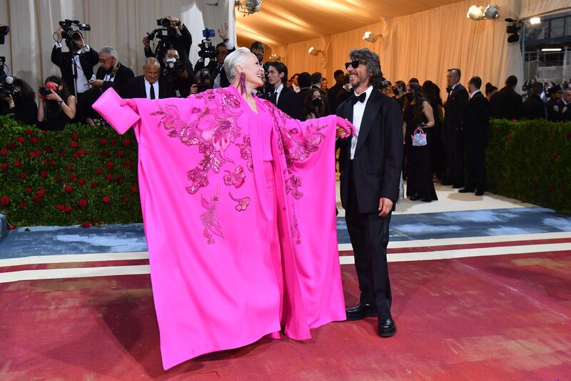 Glenn Close, in a pink caped dress, and Italian designer Pier Paolo Pasolini. AFP